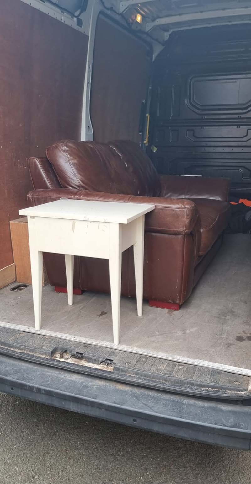 Sofa and table being transported in a van